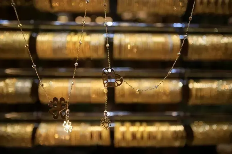 Image accompanying: Gold gains on softer dollar, but heads for weekly fall
